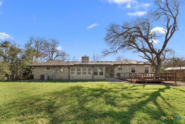 back of house with central air condition unit, a wooden deck, a lawn, french doors, and a chimney