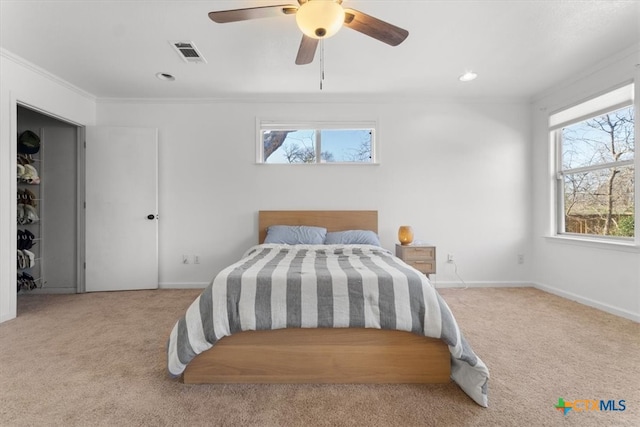 carpeted bedroom with visible vents, ornamental molding, recessed lighting, baseboards, and ceiling fan