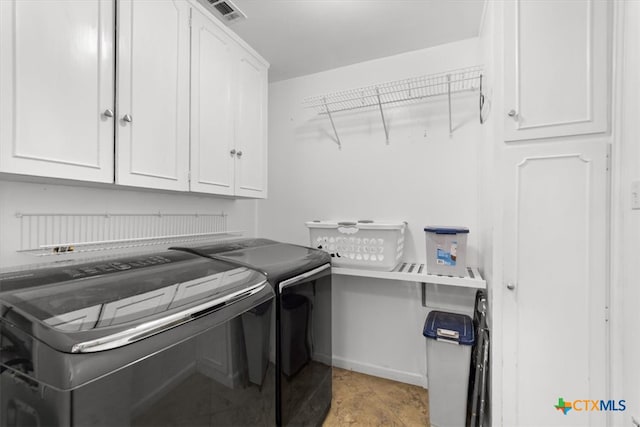 laundry room featuring cabinet space, washing machine and dryer, and visible vents