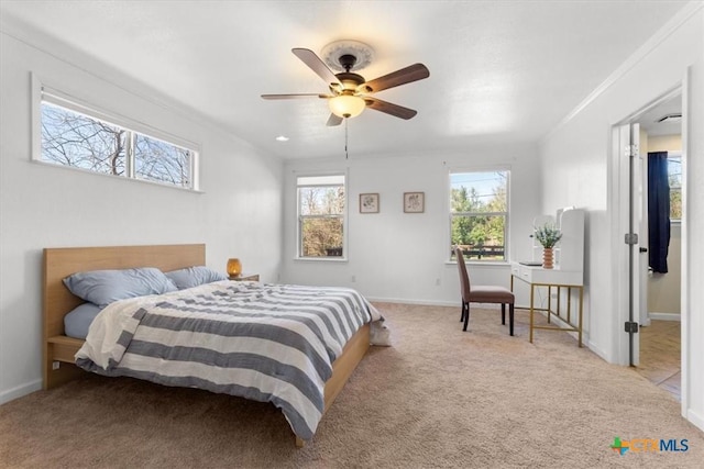 bedroom featuring multiple windows, crown molding, and carpet floors