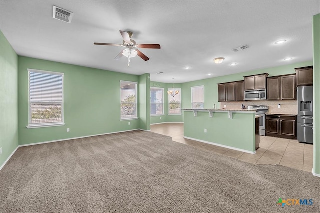 kitchen with light carpet, visible vents, stainless steel appliances, and light countertops