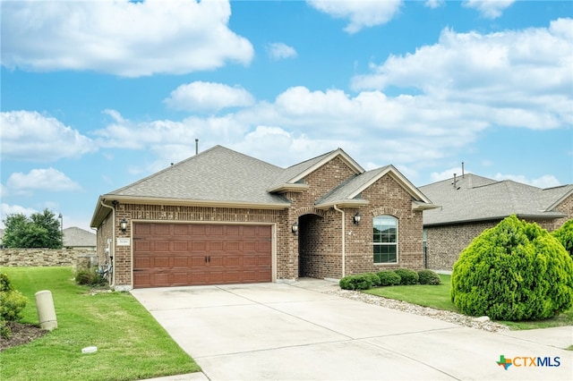 view of front of property with a garage and a front yard