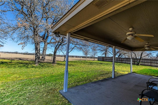 view of patio with ceiling fan and a rural view