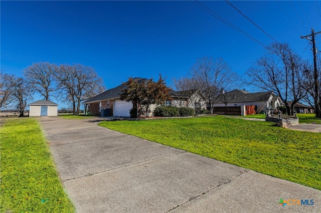 ranch-style house featuring a storage shed, a front yard, and a garage