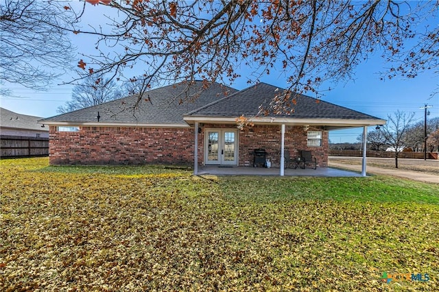 rear view of house with a patio, a yard, and french doors