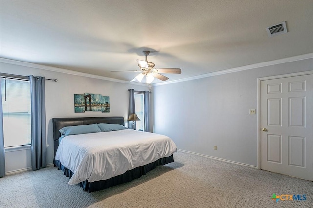 carpeted bedroom with multiple windows, crown molding, and ceiling fan