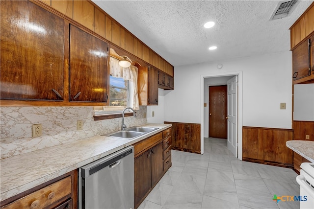 kitchen featuring sink, a textured ceiling, stainless steel dishwasher, white stove, and decorative backsplash