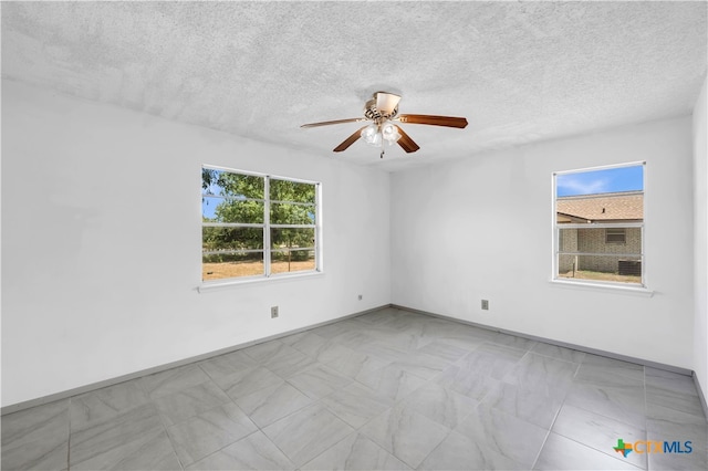 unfurnished room with a textured ceiling and ceiling fan