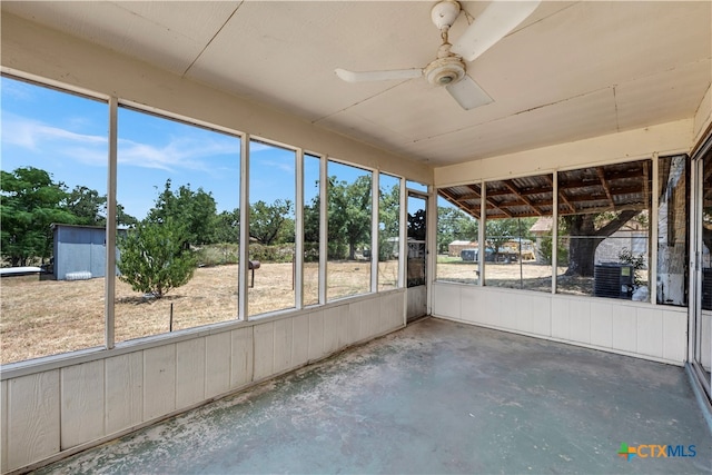 unfurnished sunroom with ceiling fan and plenty of natural light