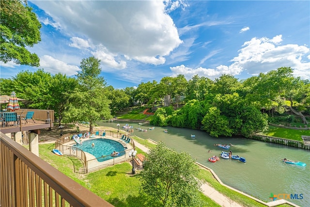 view of swimming pool featuring a water view