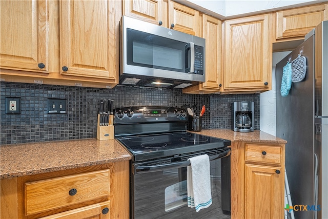 kitchen featuring stainless steel appliances, tasteful backsplash, and light stone counters