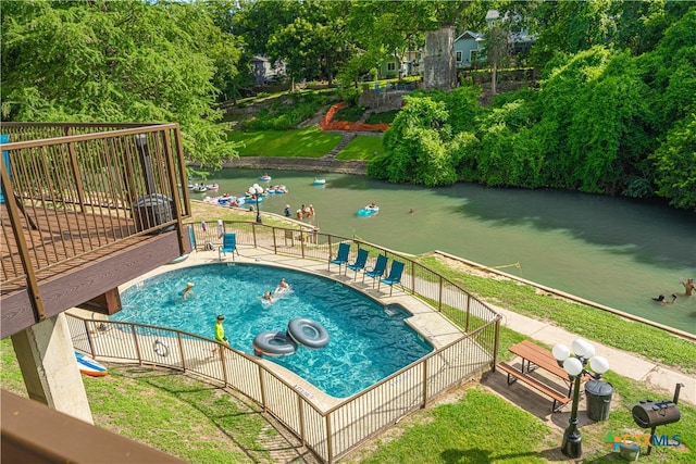 view of swimming pool with a water view