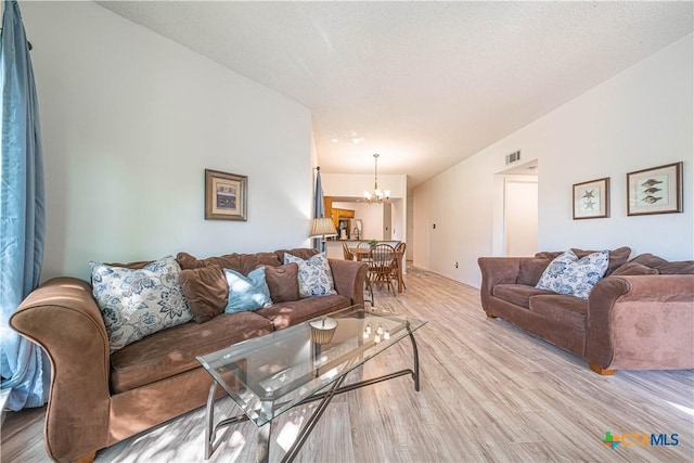 401 W Lincoln St Unit A201, New Braunfels, TX 78130 - living area with a chandelier and light wood finished floors