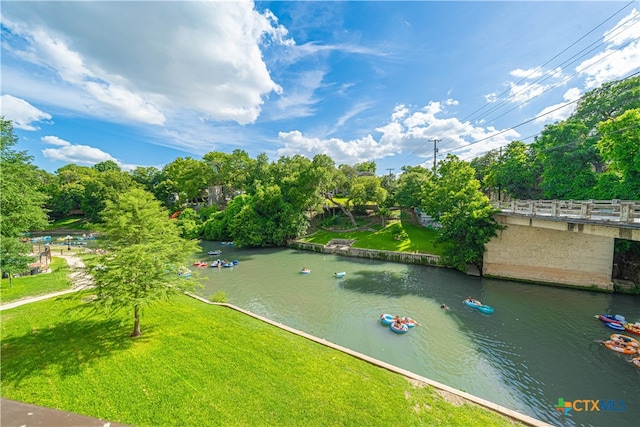 view of property's community featuring a water view and a yard