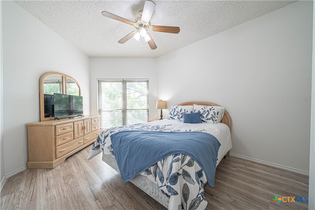 bedroom featuring a textured ceiling, dark hardwood / wood-style flooring, and ceiling fan