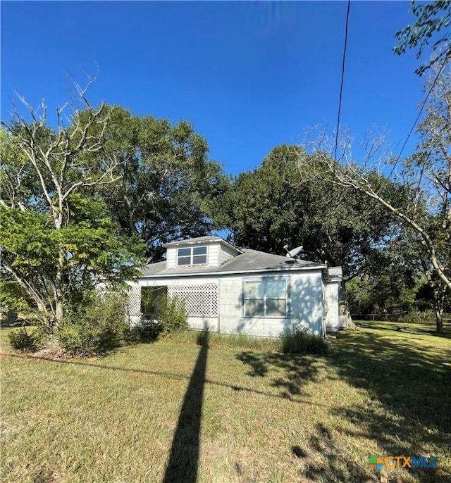 view of side of property featuring a yard