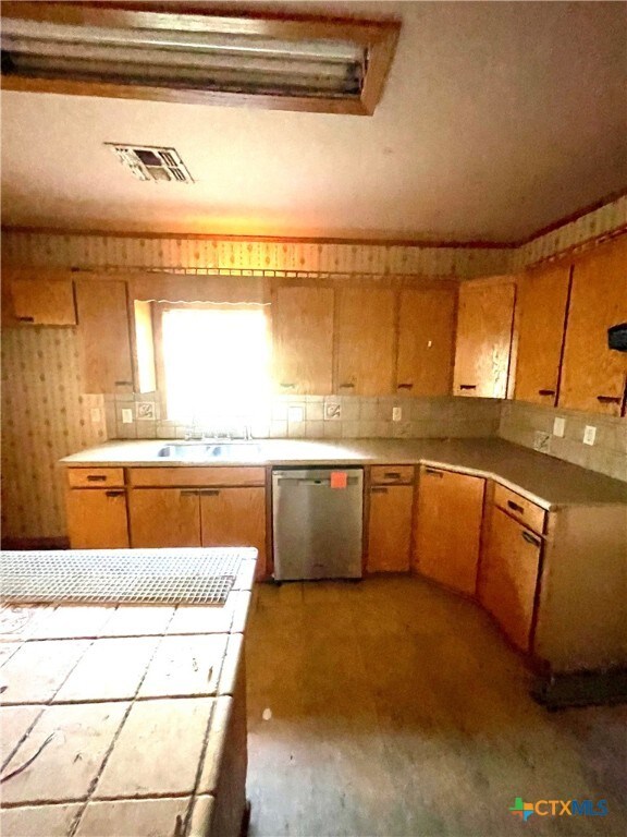 kitchen with dishwasher and light wood-type flooring