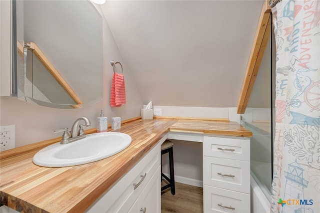 521 Woodhaven Dr, Ingleside, TX 78362 - full bathroom with vanity, wood finished floors, and shower / tub combo with curtain