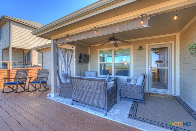 wooden terrace with outdoor lounge area and ceiling fan