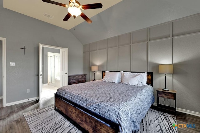 bedroom featuring ceiling fan, wood-type flooring, ensuite bathroom, and lofted ceiling