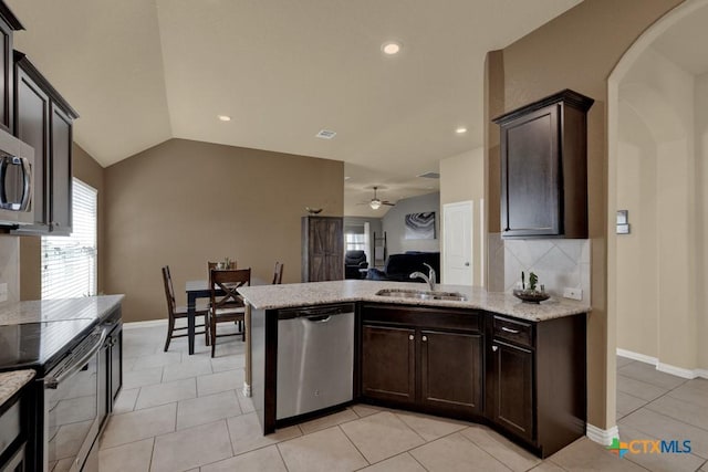 kitchen with stainless steel appliances, lofted ceiling, sink, and dark brown cabinetry