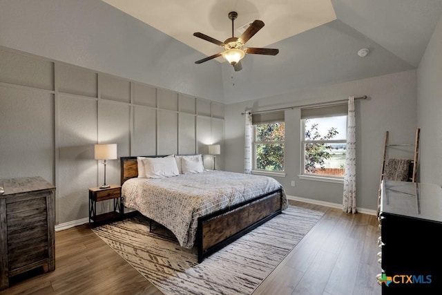 bedroom featuring ceiling fan, wood-type flooring, and vaulted ceiling