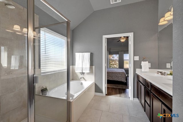 bathroom featuring shower with separate bathtub, lofted ceiling, a healthy amount of sunlight, and tile patterned floors