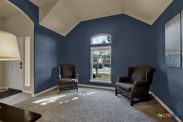 living area featuring lofted ceiling and light carpet