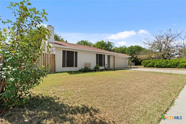 ranch-style home with a garage and a front yard