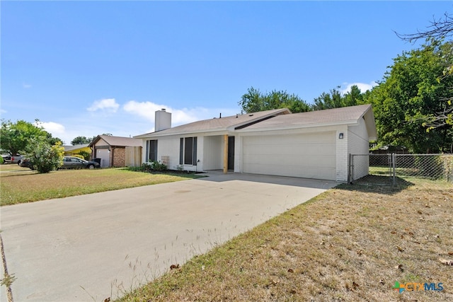 single story home featuring a garage and a front yard