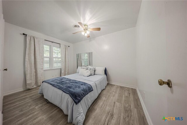 2613 Goliad St, Temple, TX 76501 - bedroom with wood finished floors, baseboards, and a ceiling fan