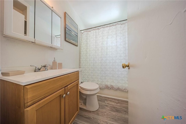 2613 Goliad St, Temple, TX 76501 - full bath with wood finished floors, toilet, and vanity