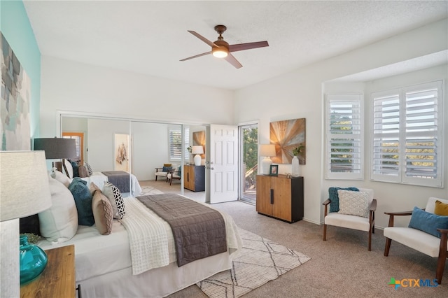 carpeted bedroom with ceiling fan, access to exterior, and multiple windows