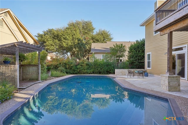 view of swimming pool with a patio area and a pergola