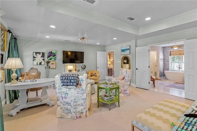 living room with ornamental molding and light carpet