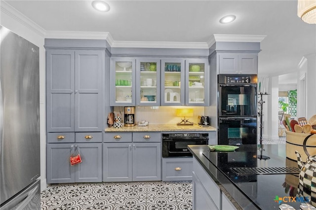 kitchen with gray cabinets, stainless steel refrigerator, double oven, and dark stone counters