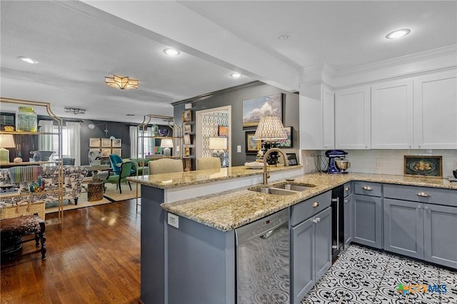 kitchen with white cabinetry, sink, stainless steel dishwasher, kitchen peninsula, and crown molding