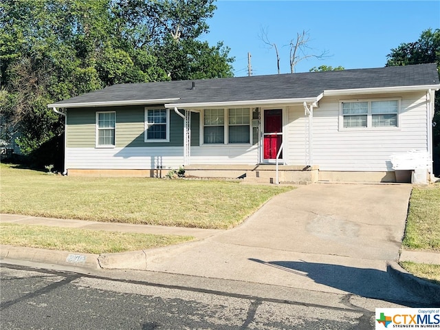 ranch-style home with covered porch and a front lawn