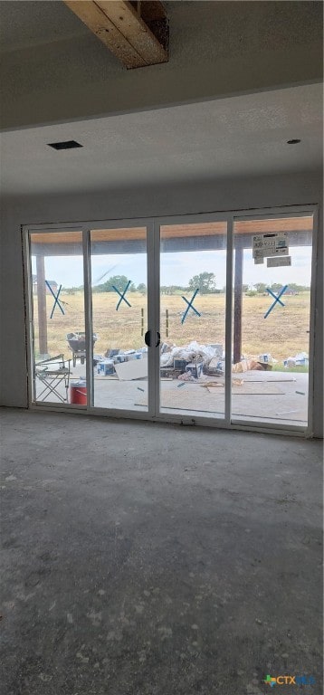 unfurnished living room featuring concrete flooring