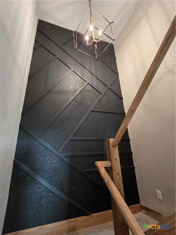 8186 S Lone Star Pkwy, Moody, TX 76657 - stairway with an inviting chandelier