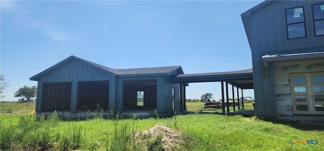 8186 S Lone Star Pkwy, Moody, TX 76657 - rear view of property with a lawn and board and batten siding
