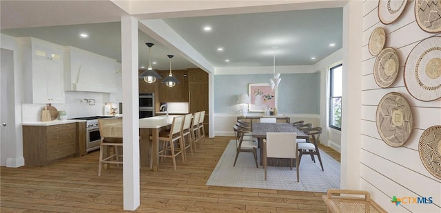 dining space featuring light hardwood / wood-style flooring and sink