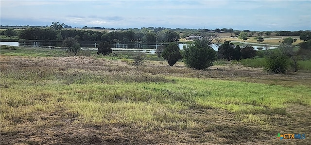 exterior space with a rural view and a water view