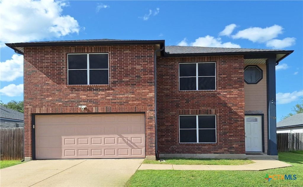 1127 Stone Arch, New Braunfels, TX 78130 - view of front facade featuring a garage, driveway, and brick siding
