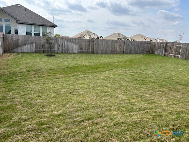 view of yard with a fenced backyard