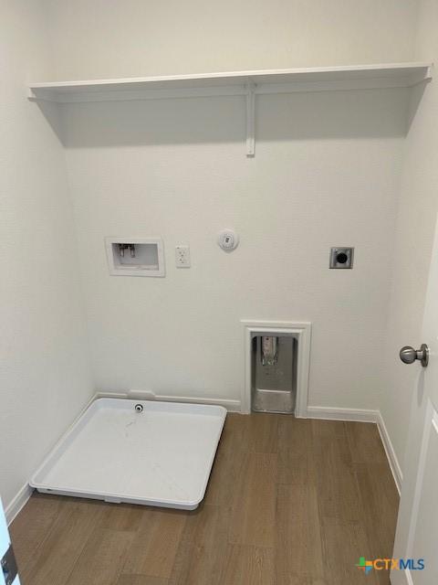 laundry area featuring laundry area, hookup for a washing machine, gas dryer hookup, and wood finished floors
