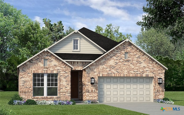 view of property featuring a front yard and a garage