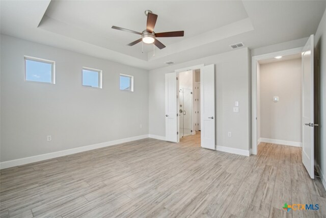 exercise room with hardwood / wood-style floors, expansive windows, and a healthy amount of sunlight