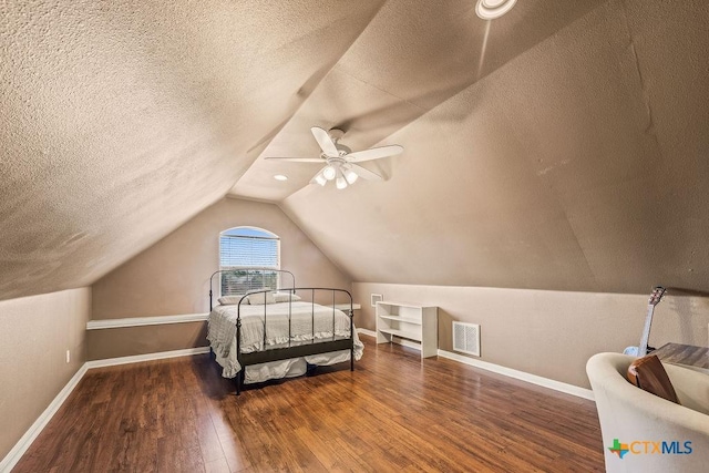 10 Long Bow Ln, Wimberley, TX 78676 - bedroom with wood finished floors, a textured ceiling, vaulted ceiling, and ceiling fan