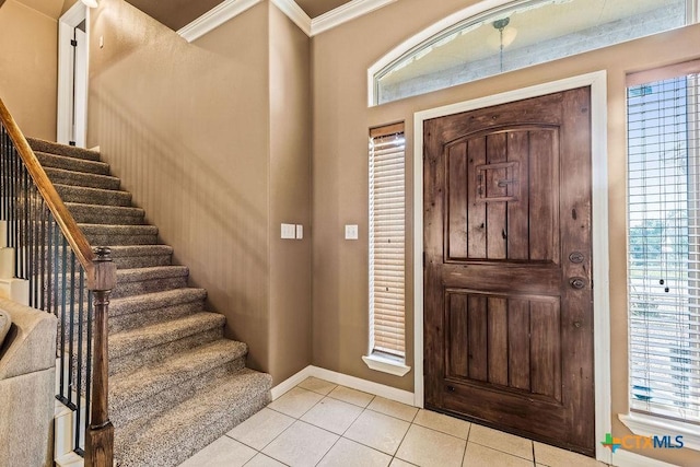 10 Long Bow Ln, Wimberley, TX 78676 - foyer featuring light tile patterned flooring, stairs, crown molding, and plenty of natural light